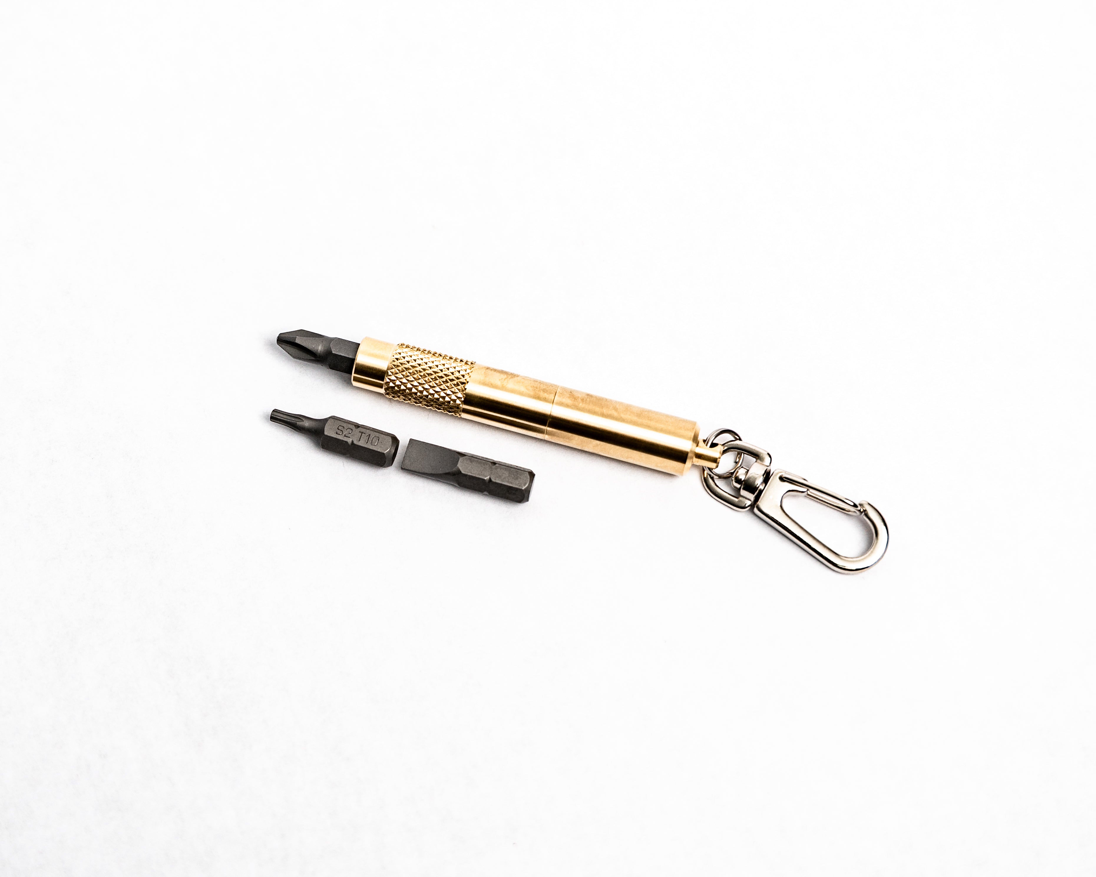 Overhead view of brass screwdriver keychain with bits