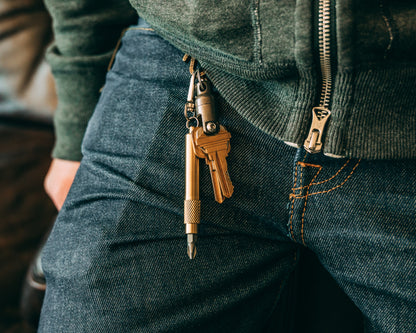 brass screwdriver keychain dangling next to keys from a brass JRW tough clip